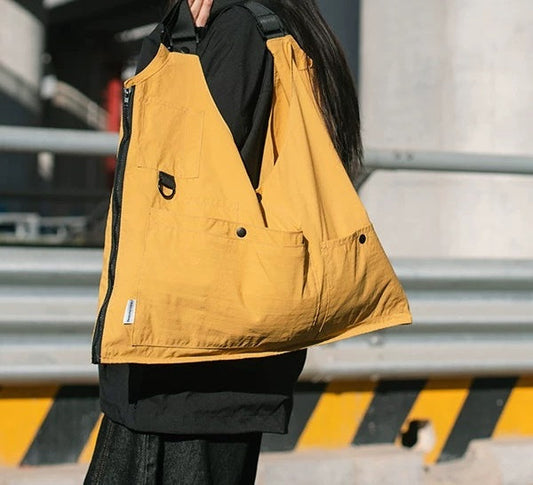 A side-by-side image showing the 9902 bag in yellow, first as a folded crossbody bag ("Front" view), and then laid flat as a vest ("Tiling" view), demonstrating its unique 1-second transformation feature.