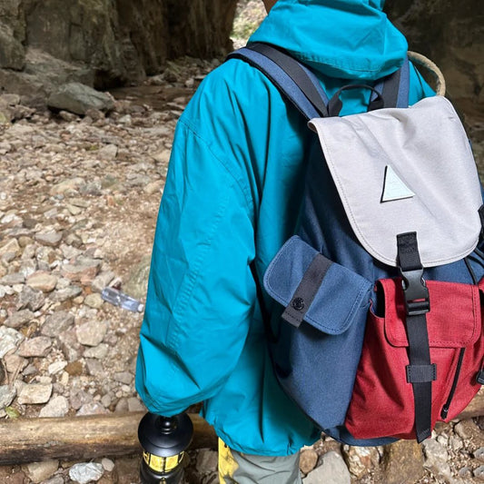 Person wearing multi-color backpack during outdoor activity showing durability for college guys