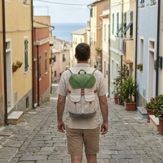 Back view of a traveler wearing the 7708 waterproof backpack walking through a colorful coastal town street