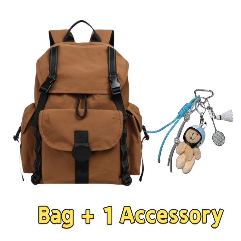Brown 7710 lightweight travel backpack 22L featuring vintage military-style design, multiple external pockets, drawstring closure, adjustable straps and one charming accessory with bear keychain and carabiners for personal expression