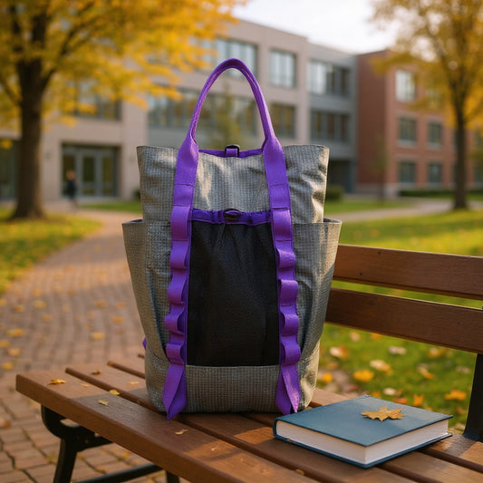 Backpackbeat 7713 Lightweight Backpack 22L gray with purple straps on university campus bench with textbooks, autumn setting with academic buildings