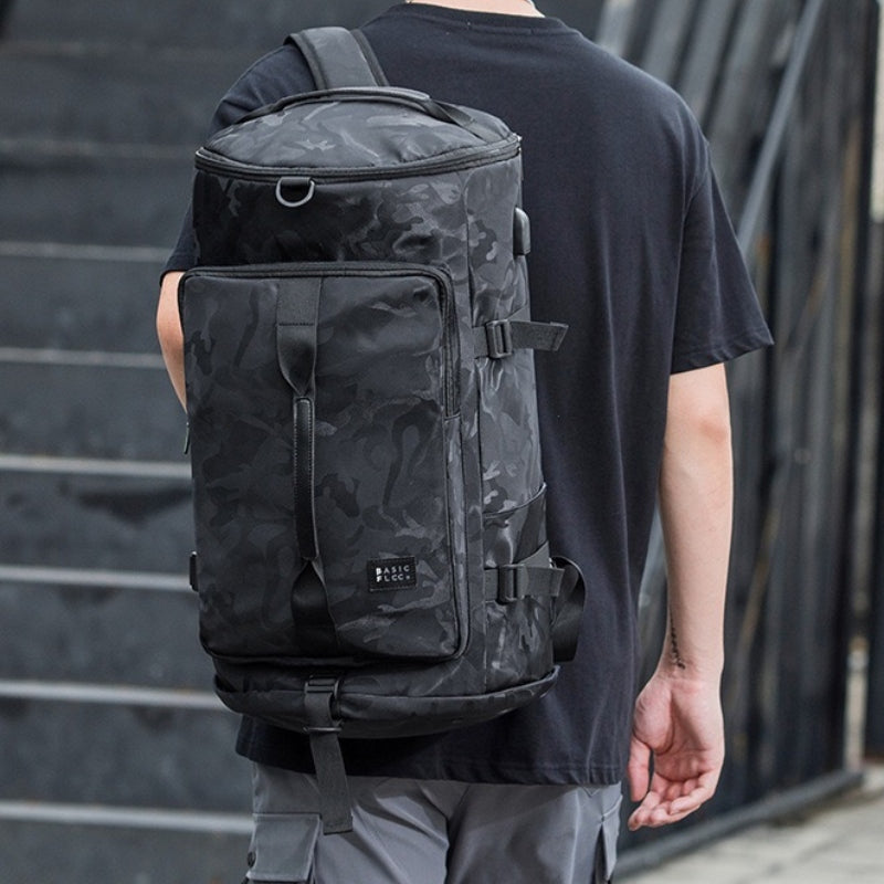 Person wearing 8801 stylish waterproof backpack 45L in black camouflage for urban commuting, demonstrating comfortable backpack mode