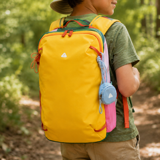 Close-up of the yellow 8810 Lightweight Hiking Backpack 14L for Kids worn on a forest trail