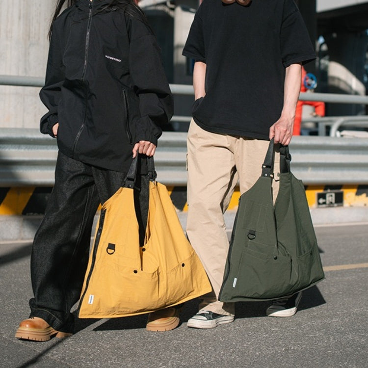 Two people carrying the yellow and green 9902 Wearable Crossbody Bags as totes, showing multi-color options and versatile design.