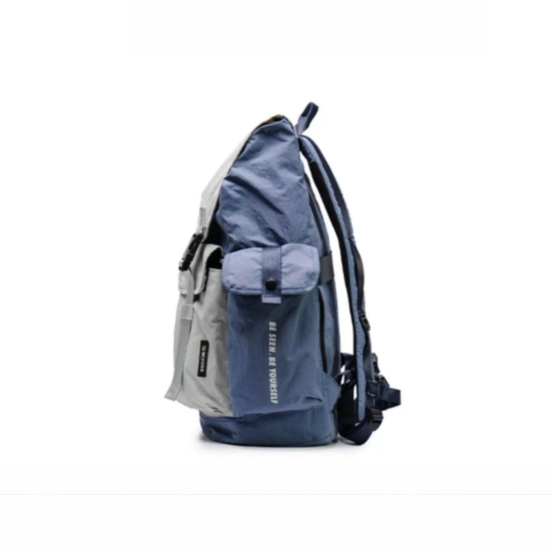Blue and gray mixed-color lightweight waterproof backpack showing side view with multiple compartments and water-resistant design