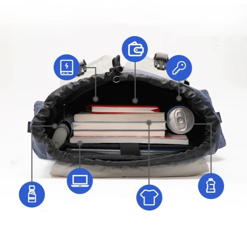 Open waterproof backpack showing interior capacity with laptop compartment, books, and travel essentials organization