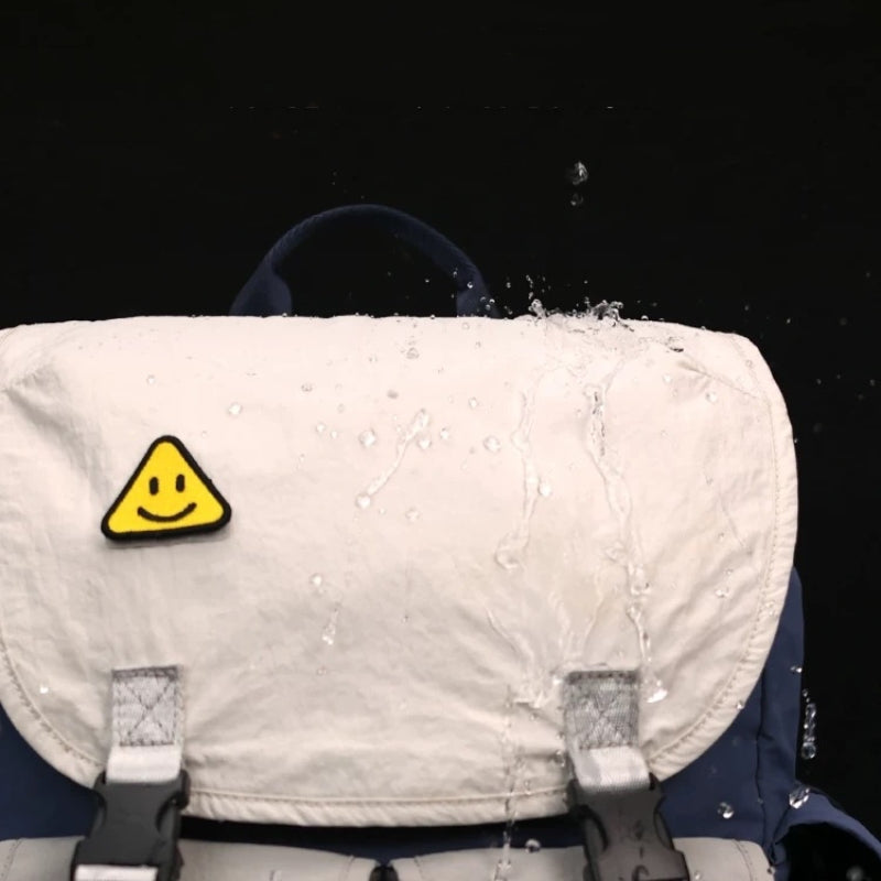 Waterproof backpack being splashed with water to demonstrate water-repellent fabric technology and weather protection