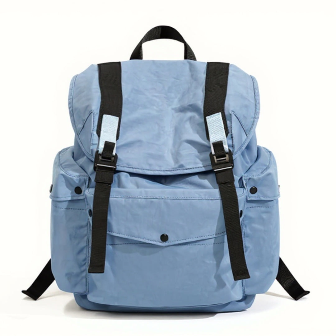 A front-facing view of the light blue Backpackbeat 7712 Lightweight Backpack 25L, isolated on a clean white background. The backpack features a modern, streamlined design with black straps and light blue accents. This image showcases the product's details and sleek aesthetics.