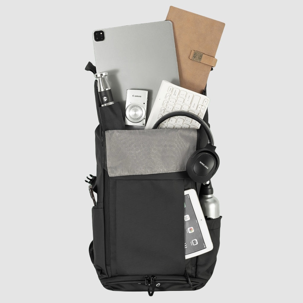 7702 waterproof backpack opened with daily essentials inside, demonstrating internal capacity