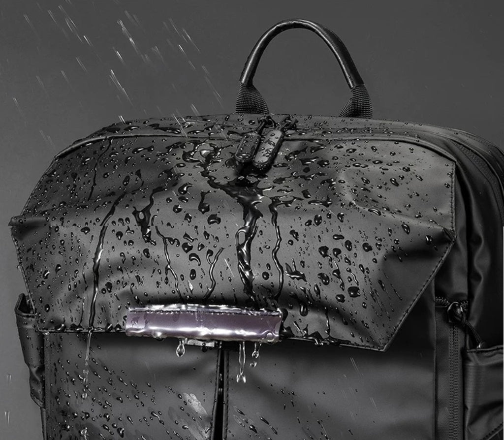 Close-up of water splashing on BackpackBeat 8808 extend waterproof backpack — zoomed waterproof fabric detail.