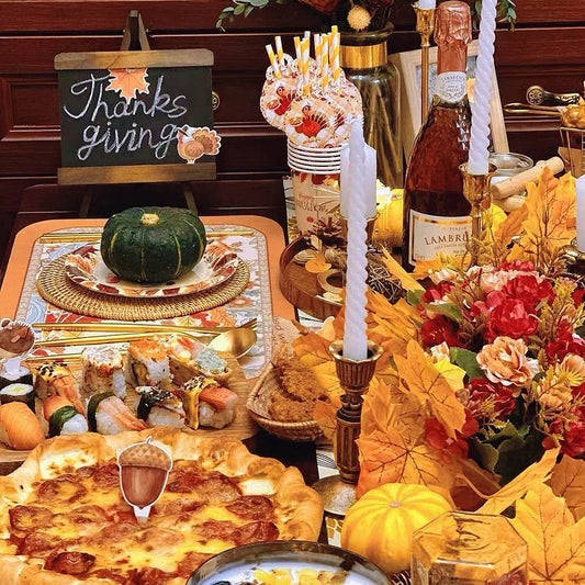 Beautifully decorated Thanksgiving dinner table with pumpkins candles and festive decorations showcasing hostess efforts