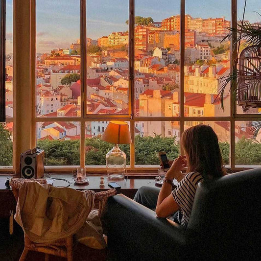 Digital nomad working in Lisbon café with panoramic city view