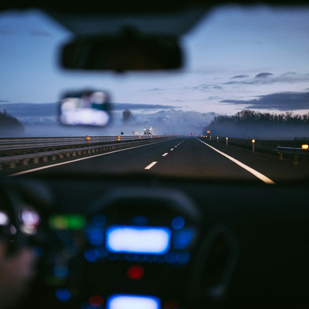 view from inside a car driving on empty road representing uncertainty and transition after long-term digital nomad life