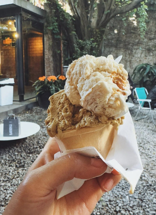 Hand holding a cone of Argentinian ice cream at Rapa Nui, Buenos Aires
