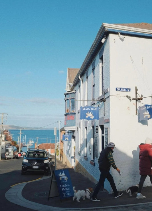 Quiet corner in Bellerive village with people walking dogs and sea glimpses at the end of the street