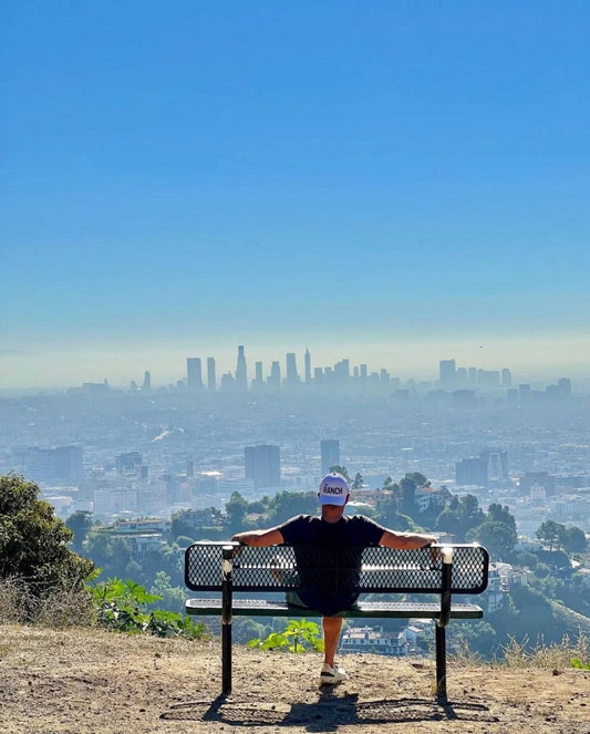 Hiker enjoying the skyline view from Griffith Park, Los Angeles