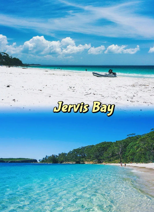 White sand beach and turquoise water at Jervis Bay with people walking and a boat on shore