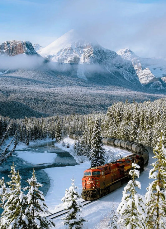 Snowy alpine lake and forest trail along the Lake Louise to Yoho Valley route in Canada