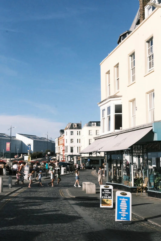 A sunny street view of Margate Old Town lined with boutique shops and cafes.