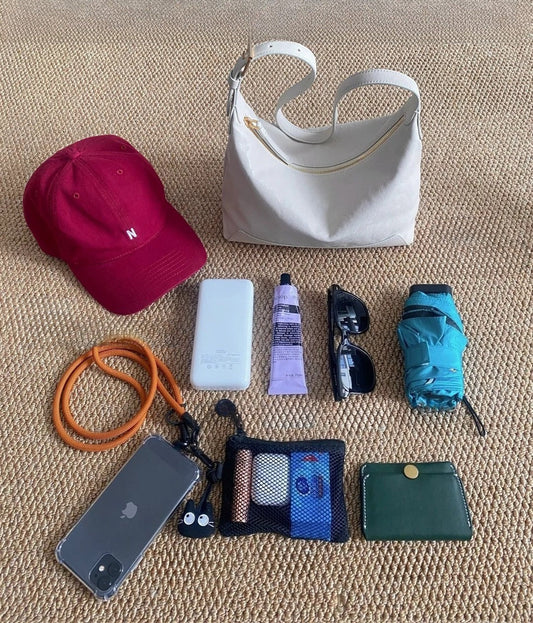 travel essentials including flip-flops, pouches, and reusable bottle