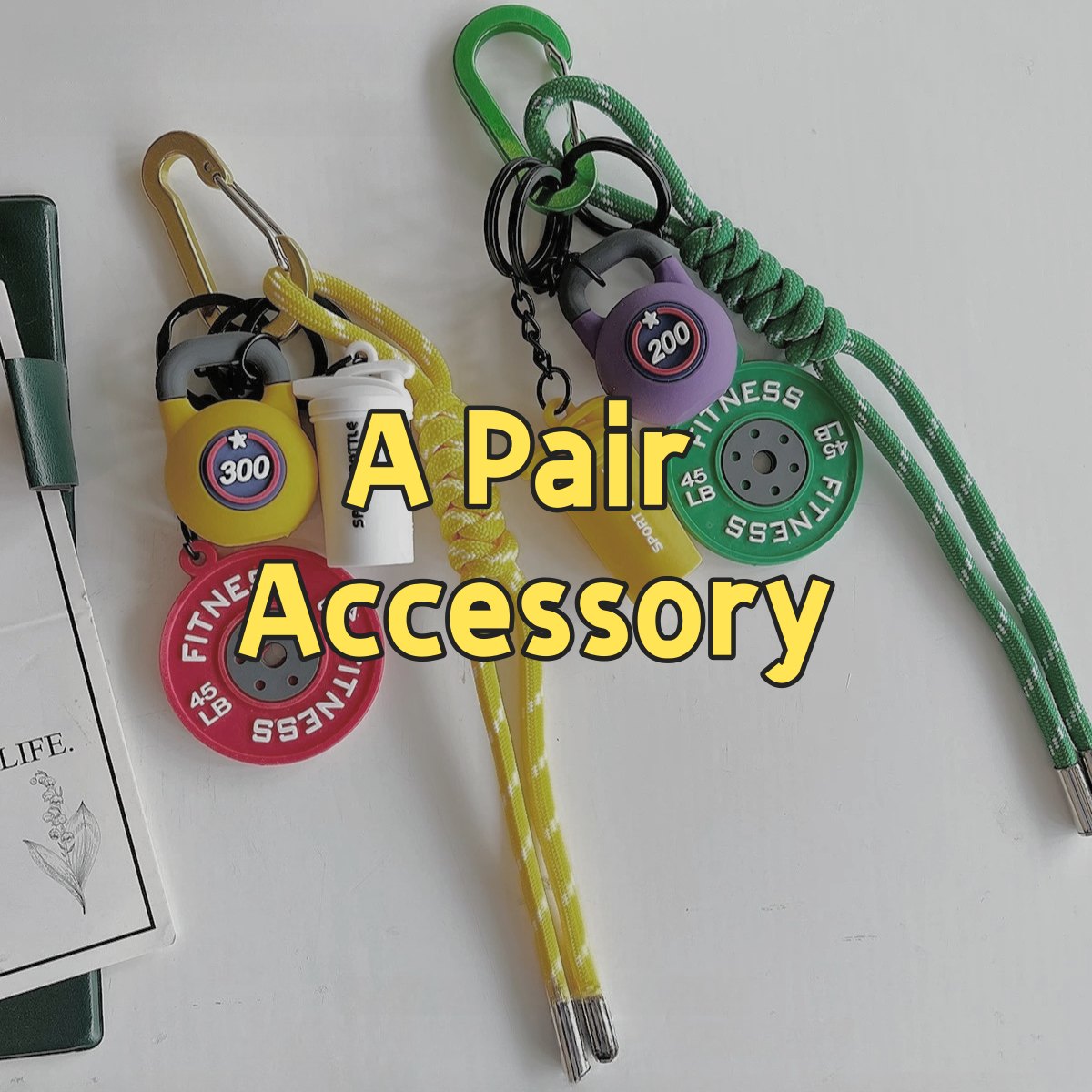 Colorful 001 fitness gear backpack accessories set showing A Pair collection with yellow, green, and purple variations featuring fitness-themed carabiners, survival tools, emergency whistle, and paracord lanyards for outdoor adventures