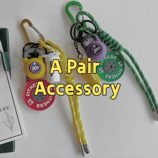 Colorful 001 fitness gear backpack accessories set showing A Pair collection with yellow, green, and purple variations featuring fitness-themed carabiners, survival tools, emergency whistle, and paracord lanyards for outdoor adventures