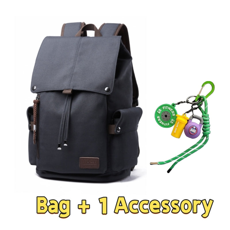 Dark grey 7704 waterproof canvas backpack 22L showcasing classic heritage design, brown leather details, vintage buckle system, side pockets and one fitness-themed accessory with green lanyard and survival gear