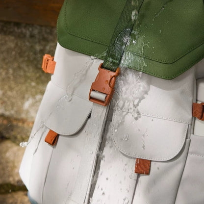 7708 stylish waterproof backpack demonstrating water-resistant properties with water droplets beading on durable fabric surface