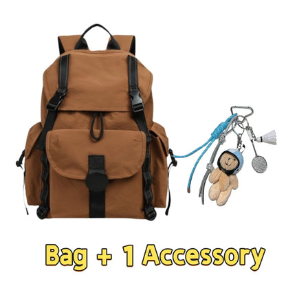 Brown 7710 lightweight travel backpack 22L featuring vintage military-style design, multiple external pockets, drawstring closure, adjustable straps and one charming accessory with bear keychain and carabiners for personal expression