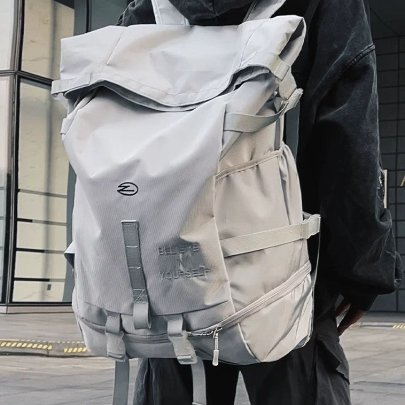 Beige 8803 waterproof backpack 34L worn by urban commuter against modern building backdrop, demonstrating professional city travel and waterproof fabric protection