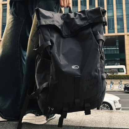 Black version of 8803 stylish waterproof backpack 34L carried by person in urban city environment, showing contemporary street style and practical daily use