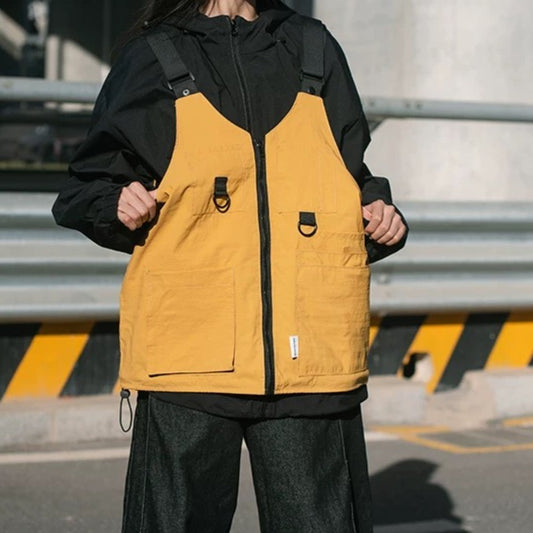 A person wearing the yellow 9902 Wearable Crossbody Bag transformed into a vest, showcasing its fit and appearance as a garment, with its front zipper and multiple pockets visible.