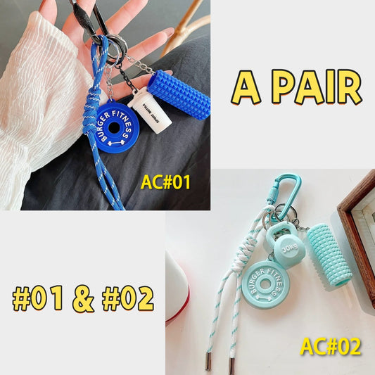 Complete pair of fitness gear keychains AC#01 and AC#02 in blue and teal colors, showing BURGER FITNESS weight plates and 30kg dumbbells with foam rollers