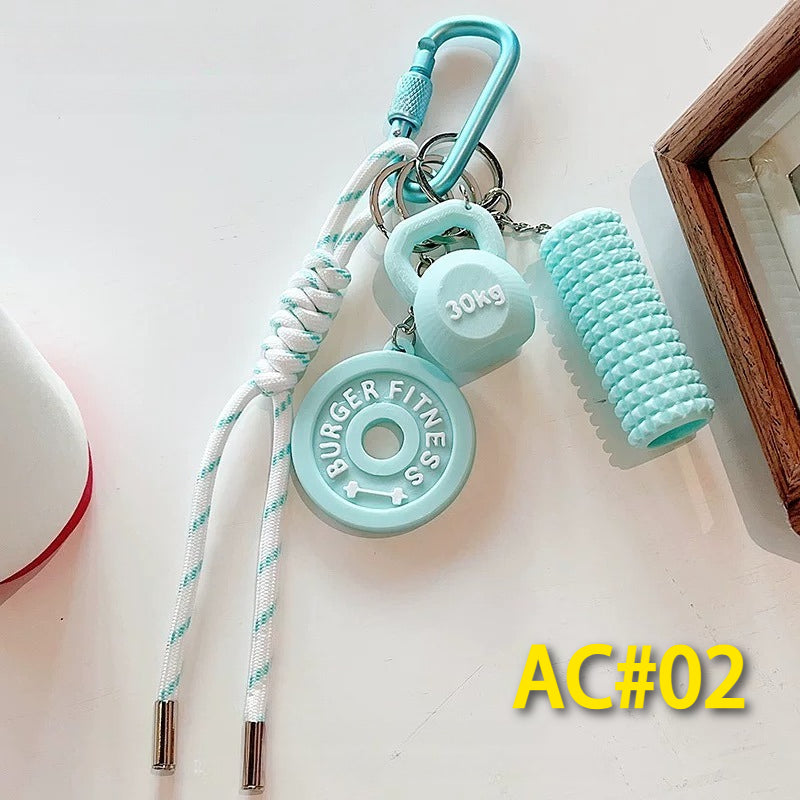 Teal fitness accessory keychain AC#02 with BURGER FITNESS weight plate, 30kg dumbbell charm, and textured foam roller with carabiner clip
