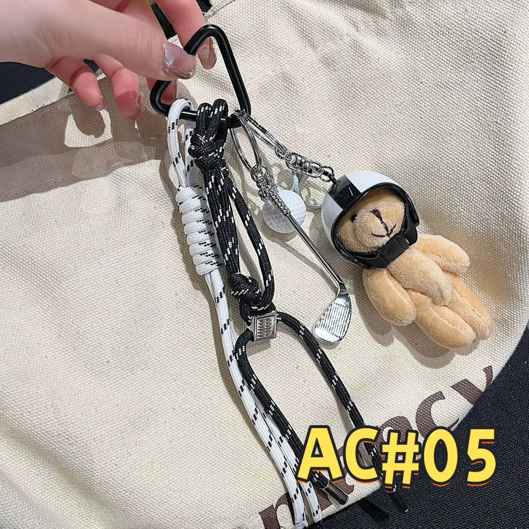 Unique black and white fitness keychain AC#05 featuring adorable teddy bear with headphones, braided cords, and premium carabiner attachment