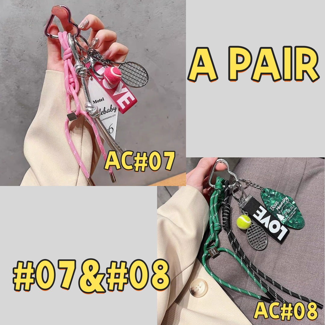 Tennis sports keychain pair AC#07 and AC#08 featuring pink and green color schemes with tennis rackets, LOVE tags, motel cards, and braided cords with carabiners