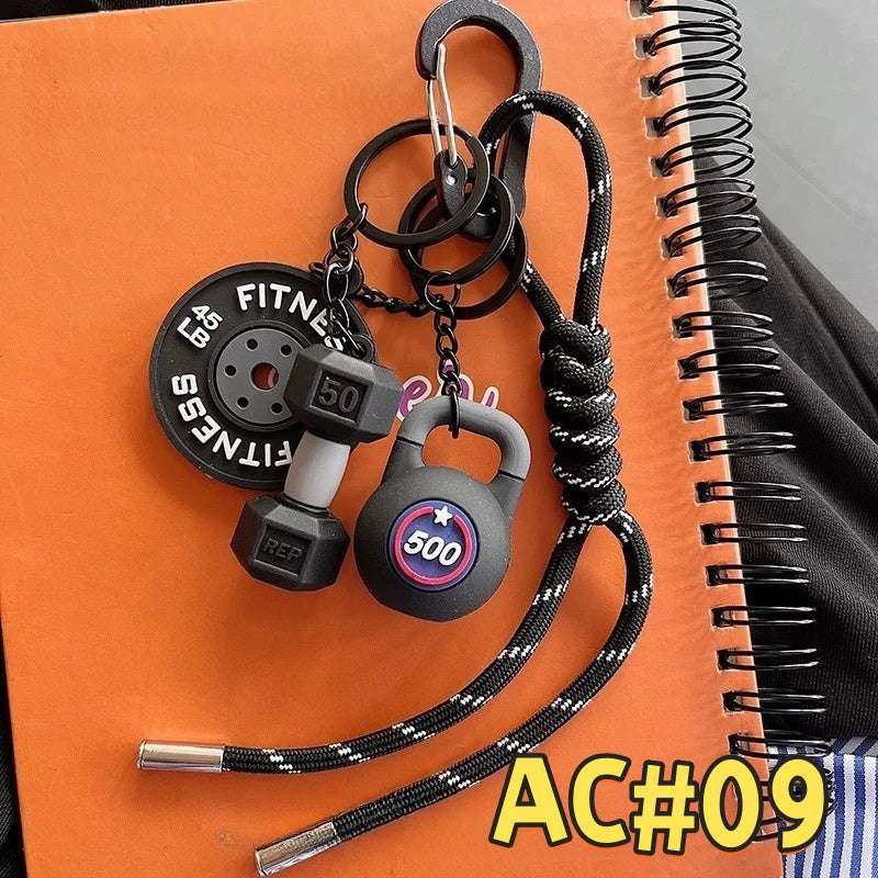 Black fitness gear keychain AC#09 featuring EG FITNESS weight plate, 500kg kettlebell, dumbbell charms with reflective braided cord
