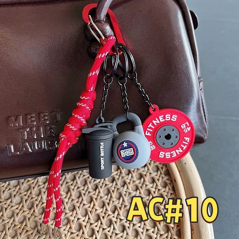 Red fitness keychain AC#10 with EG FITNESS weight plate, kettlebell, Sport Bottle tag attached to leather bag with reflective cord