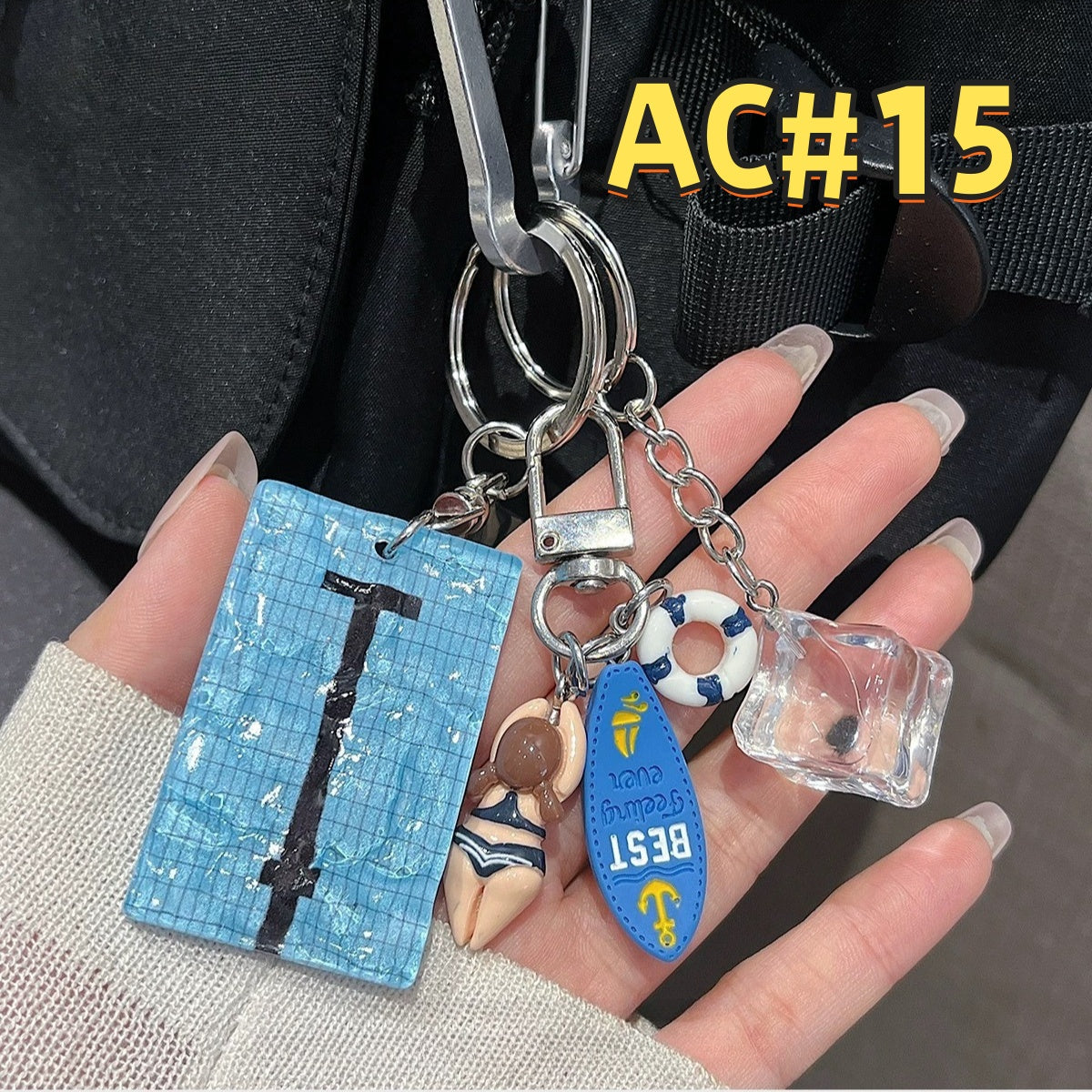 Swimming pool themed keychain AC#15 with blue mosaic pool tile design, swimmer figure, life ring, Best card, and clear cube charm
