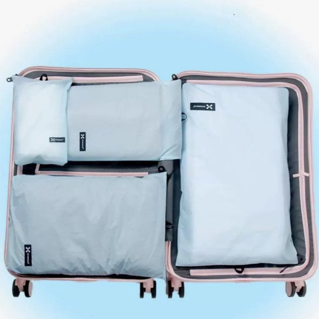 Set of BackpackBeat waterproof wet dry bags neatly packed inside pastel pink suitcase for organized travel storage