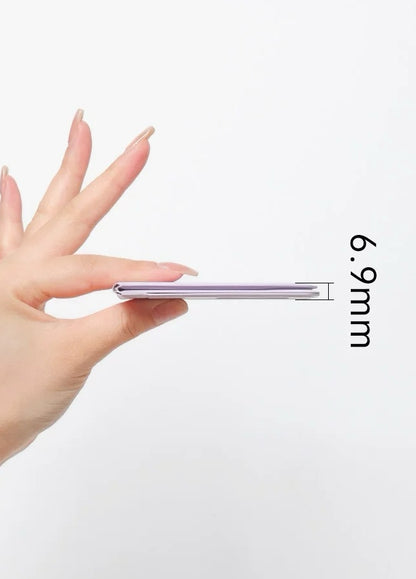 Hand holding BackpackBeat 1104 folded phone stand showing ultra-thin 6.9mm profile