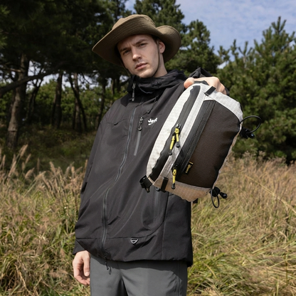 Male hiker holding BackpackBeat 9903 lightweight crossbody chest bag in forest setting