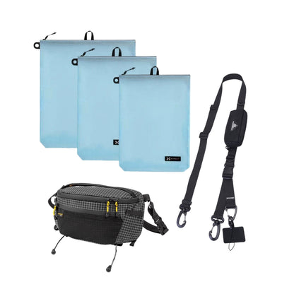 Modular travel accessories set including a black crossbody bag, adjustable modular strap, and three pastel blue waterproof organizer pouches — perfect for travel and everyday carry.