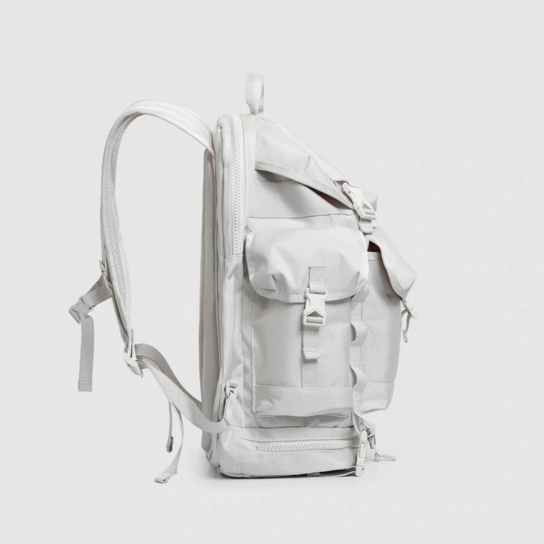 Side view of gray lightweight hiking backpack displaying vertical profile and multiple access points