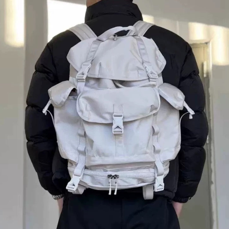Person wearing gray lightweight hiking backpack showing ergonomic fit and adjustable shoulder straps