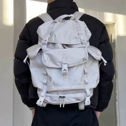Person wearing gray lightweight hiking backpack showing ergonomic fit and adjustable shoulder straps
