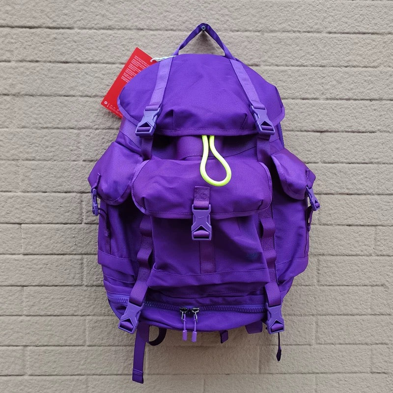 Purple 40L lightweight hiking backpack featuring front pocket, side compartments, and bottom zip section for gear organization