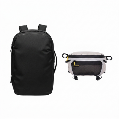 The nomad gear set showing black 28L travel backpack front view and white grey ripstop 3-in-1 chest bag with yellow zipper and black carabiner clips on white background