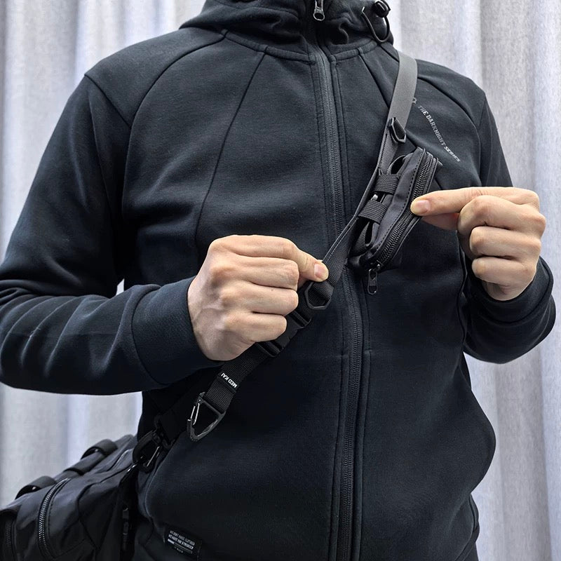 Close-up showing the front quick-adjustment zone and small storage pocket of the 1101 modular crossbody strap, designed for daily convenience.