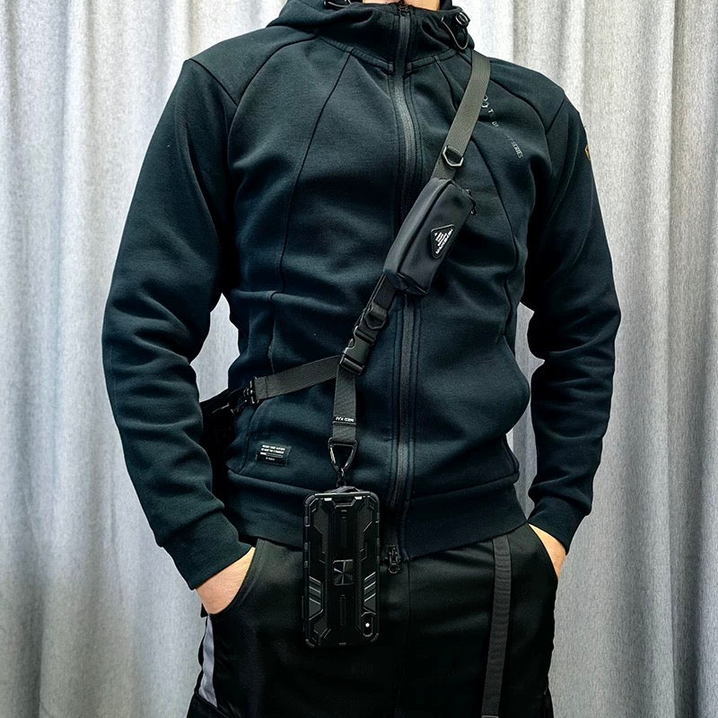 Model wearing the 1101 modular crossbody strap in a crossbody position with attached phone case, showcasing everyday travel setup.